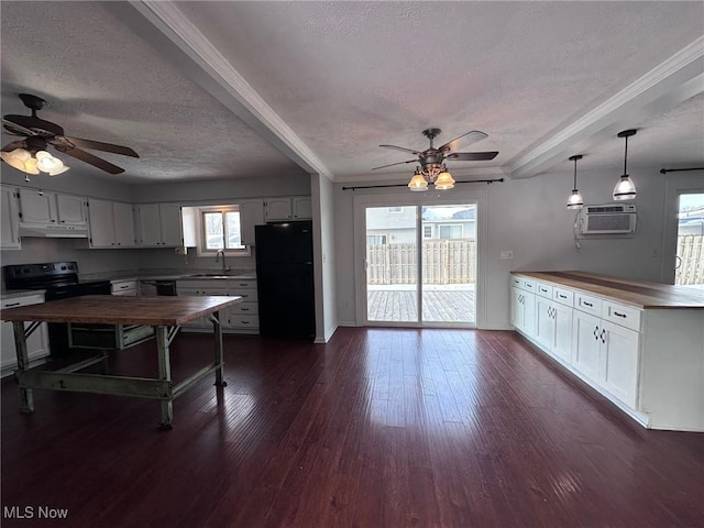 kitchen with white cabinets, dark wood finished floors, black appliances, and a wall mounted AC