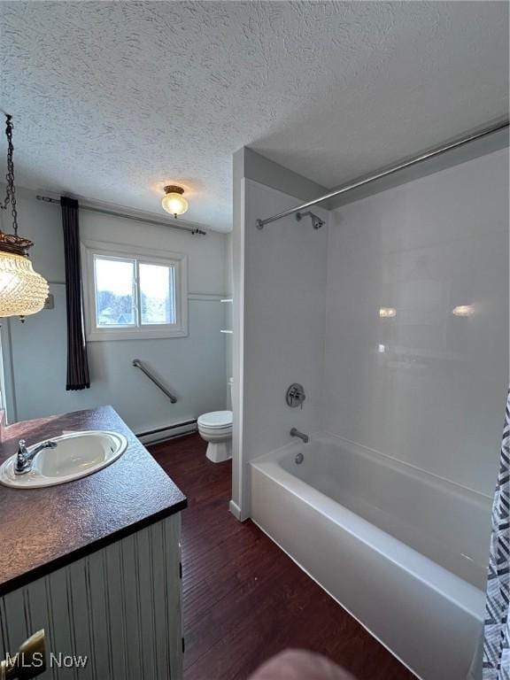 bathroom featuring toilet, a baseboard radiator, wood finished floors, a textured ceiling, and vanity