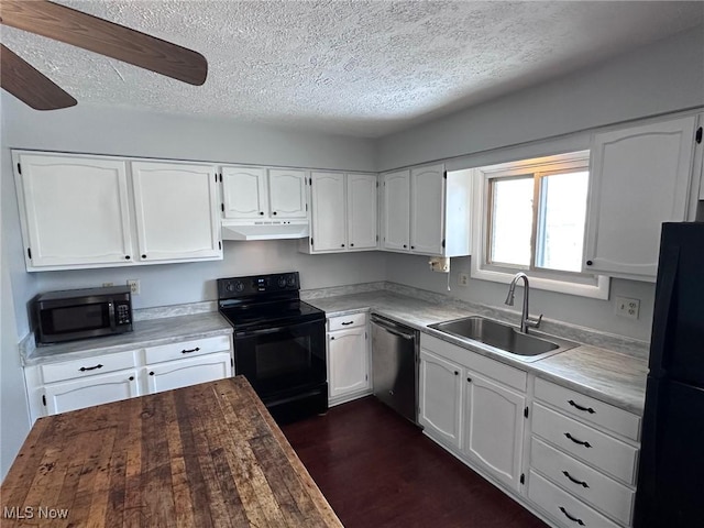 kitchen featuring under cabinet range hood, a textured ceiling, black appliances, white cabinetry, and a sink