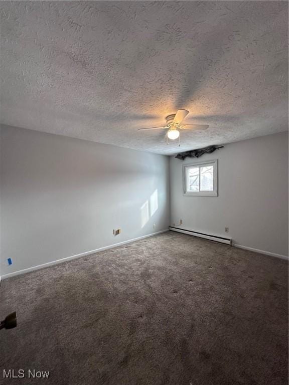 unfurnished room with a baseboard heating unit, carpet flooring, a ceiling fan, and baseboards