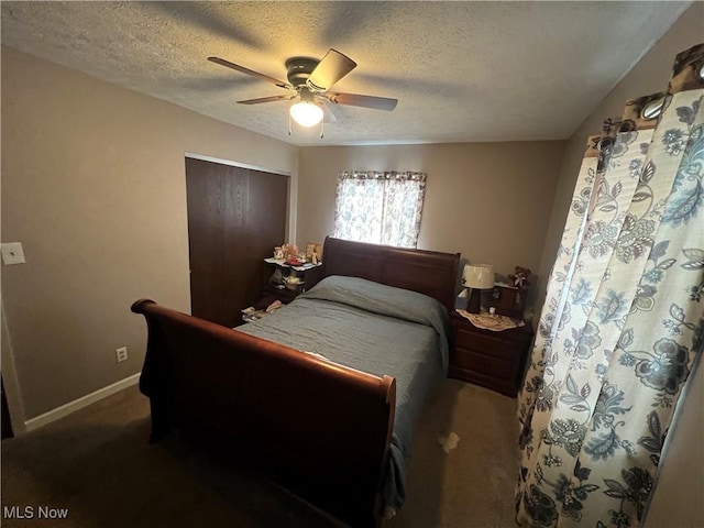 carpeted bedroom with baseboards, a closet, a ceiling fan, and a textured ceiling