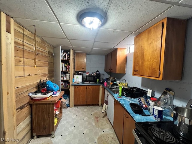 kitchen with dark countertops, brown cabinets, and range with electric cooktop