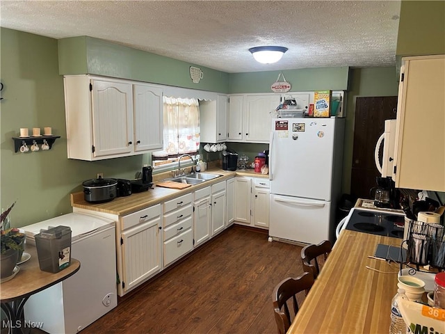 kitchen with light countertops, white appliances, white cabinetry, and a sink