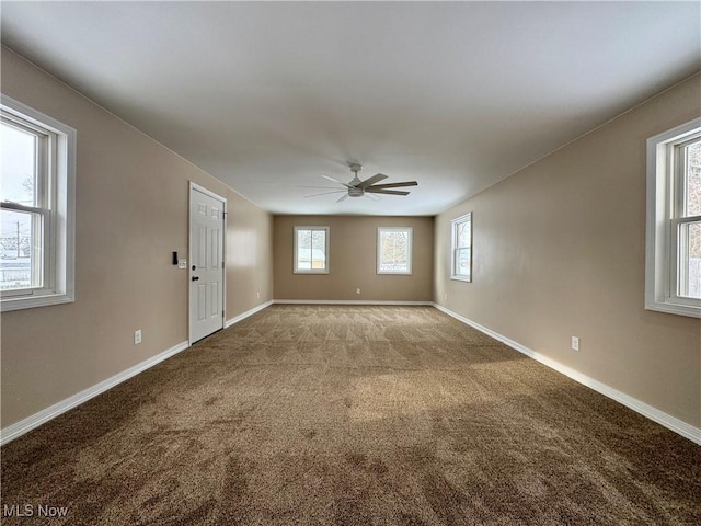 unfurnished living room featuring carpet, ceiling fan, and baseboards