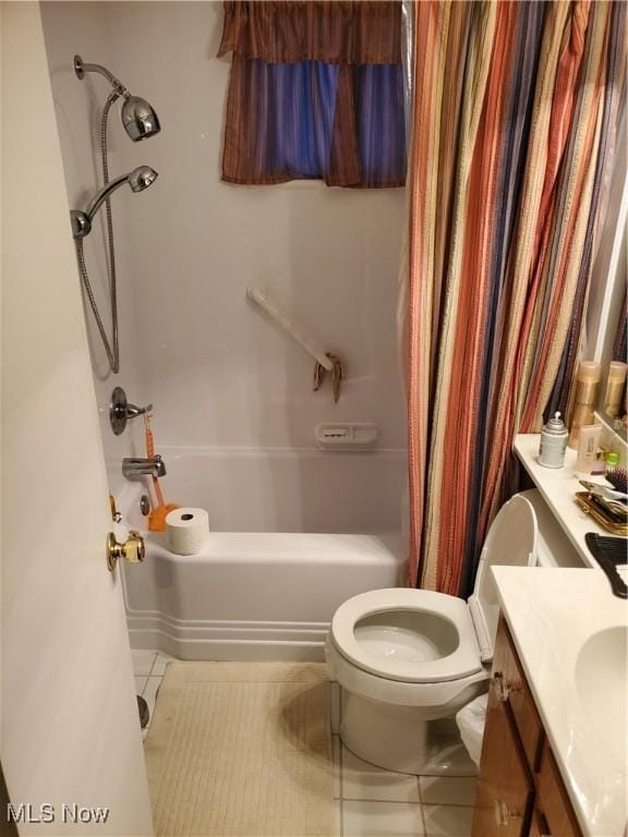 full bathroom with toilet, vanity, shower / bath combo with shower curtain, and tile patterned floors