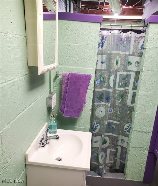 full bath featuring a shower stall and vanity