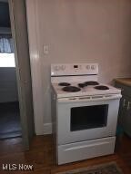 kitchen with white range with electric stovetop and light countertops