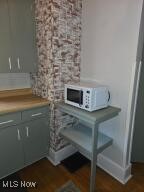 interior space featuring light countertops and white microwave