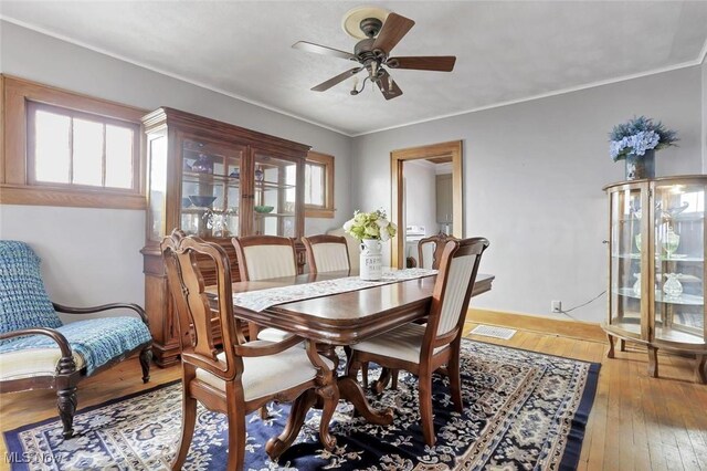 1304 Foster Ave, Cambridge, OH 43725 - dining area featuring visible vents, ceiling fan, baseboards, and hardwood / wood-style flooring