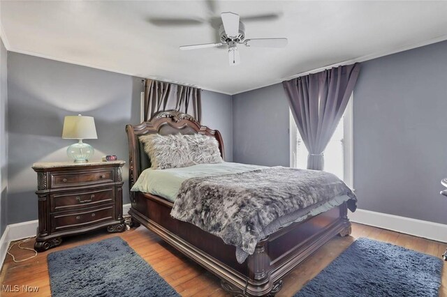 1304 Foster Ave, Cambridge, OH 43725 - bedroom with ceiling fan, baseboards, and wood finished floors