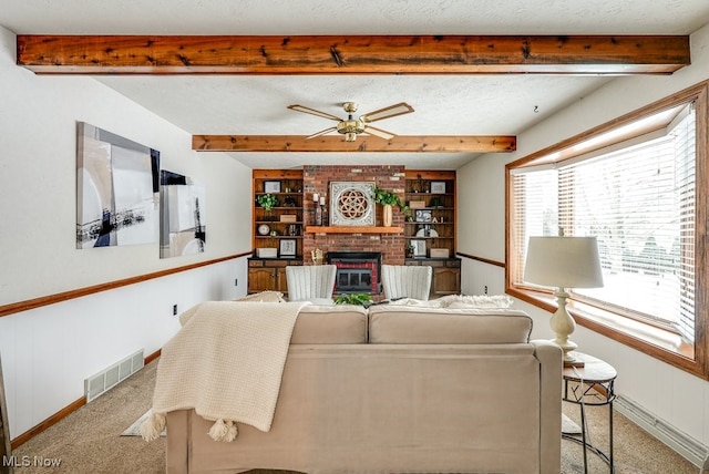 living room with light colored carpet, a brick fireplace, visible vents, and a textured ceiling