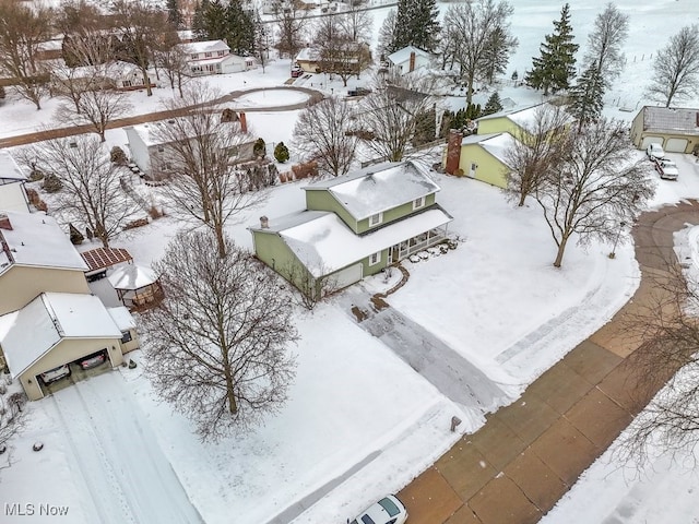 snowy aerial view featuring a residential view