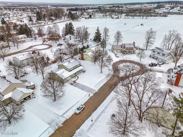 snowy aerial view with a residential view