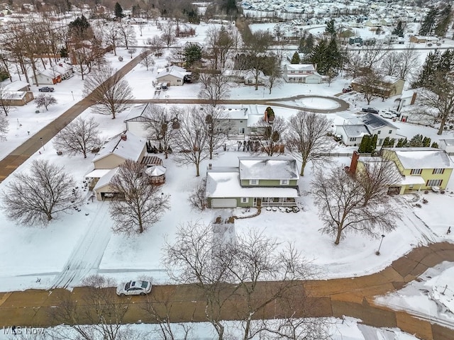 snowy aerial view with a residential view