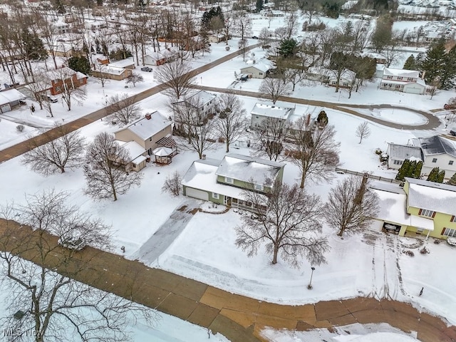 snowy aerial view featuring a residential view