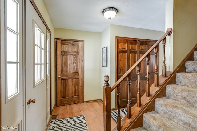 interior space with baseboards and wood finished floors