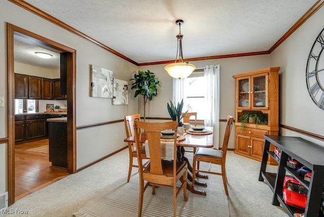 dining space with light carpet, a textured ceiling, and baseboards