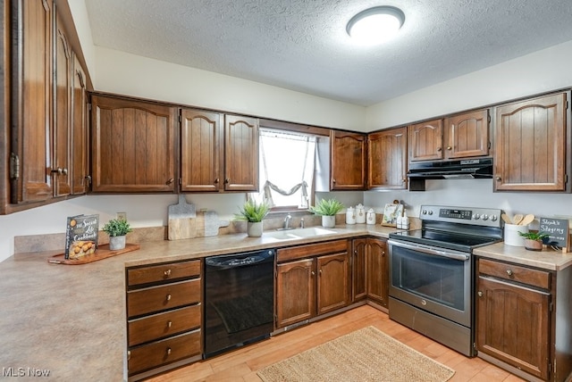 kitchen featuring under cabinet range hood, a sink, light countertops, dishwasher, and stainless steel range with electric stovetop