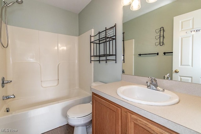 bathroom featuring toilet, tub / shower combination, and vanity