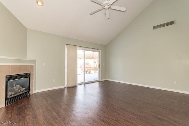 unfurnished living room featuring dark wood-style flooring, ceiling fan, baseboards, a tile fireplace, and visible vents