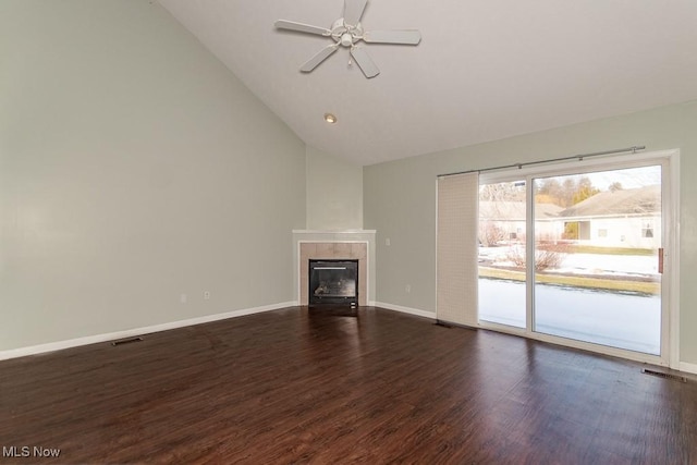 unfurnished living room with ceiling fan, a tile fireplace, visible vents, baseboards, and dark wood-style floors