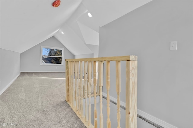 bonus room featuring lofted ceiling, baseboards, and light colored carpet