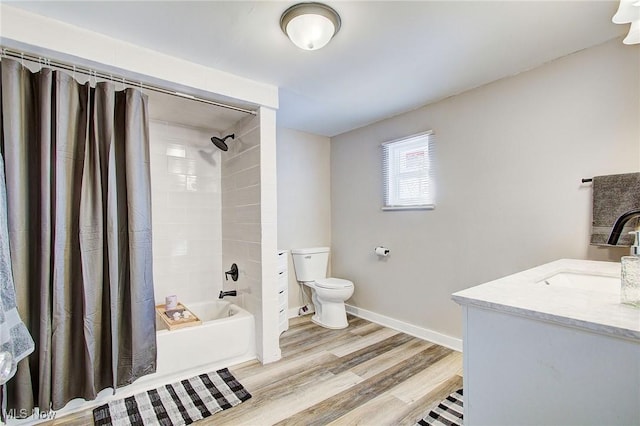 full bath with toilet, shower / bath combo with shower curtain, vanity, wood finished floors, and baseboards