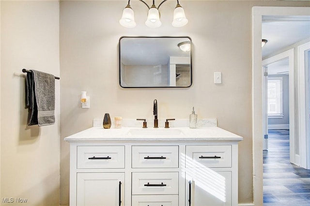 bathroom featuring wood finished floors and vanity