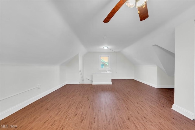 bonus room with lofted ceiling, ceiling fan, baseboards, and wood finished floors