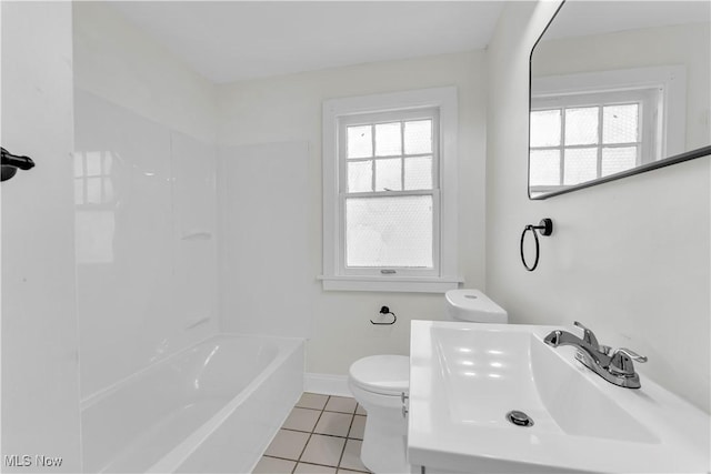 bathroom with baseboards, plenty of natural light, toilet, and tile patterned floors