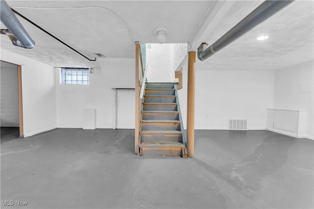 basement featuring stairway and visible vents