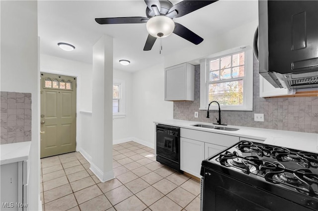 kitchen with light tile patterned flooring, a sink, white cabinetry, black appliances, and tasteful backsplash