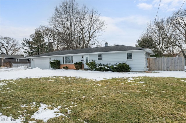 single story home with a yard, fence, and an attached garage