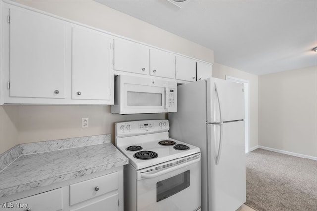 kitchen with white appliances, light countertops, and white cabinetry