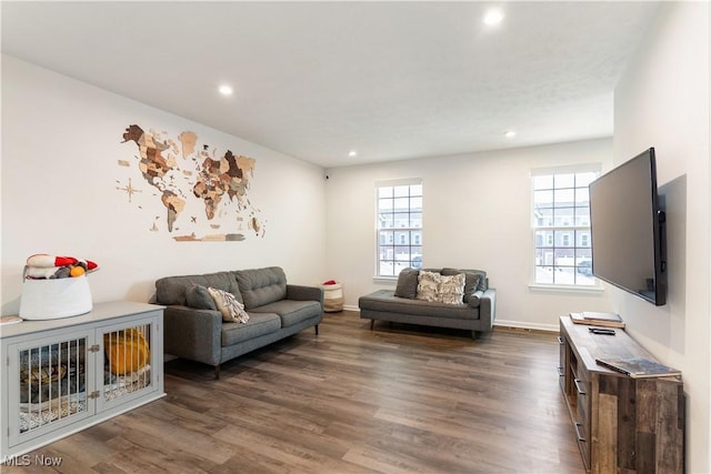 living area with baseboards, dark wood-style flooring, and recessed lighting