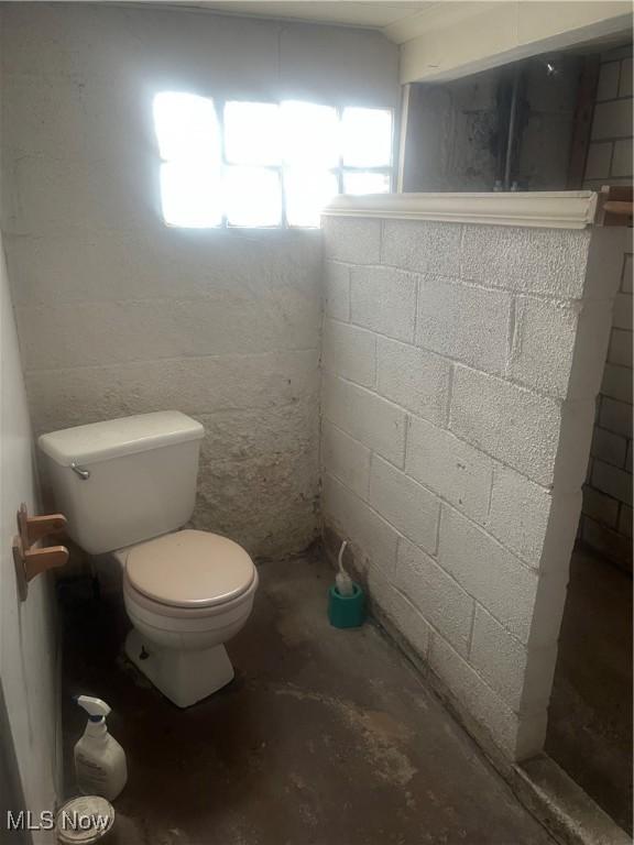 bathroom featuring toilet and concrete floors