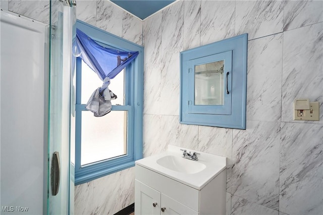 bathroom with vanity and tile walls