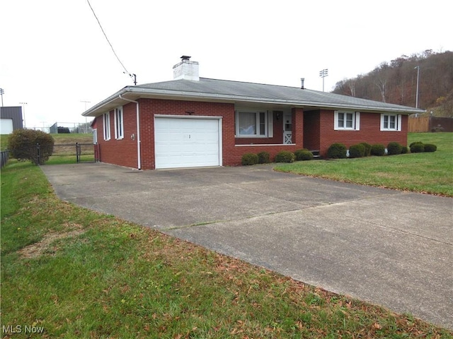 ranch-style home with concrete driveway, brick siding, an attached garage, and a front yard