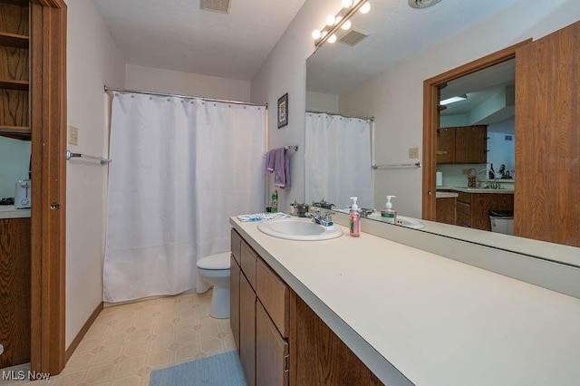 bathroom with baseboards, visible vents, toilet, tile patterned floors, and vanity