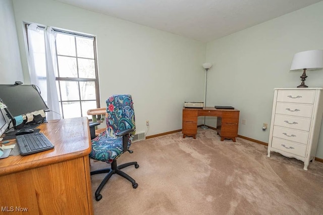 home office featuring light carpet, visible vents, and baseboards