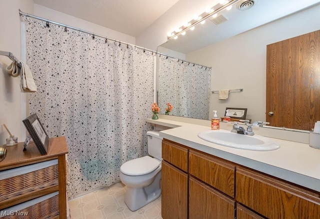 bathroom featuring visible vents, vanity, and toilet