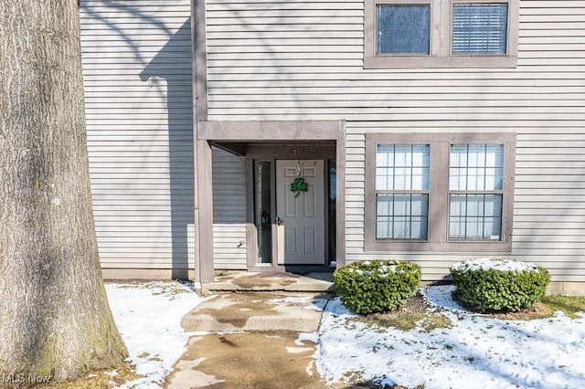 view of snow covered property entrance