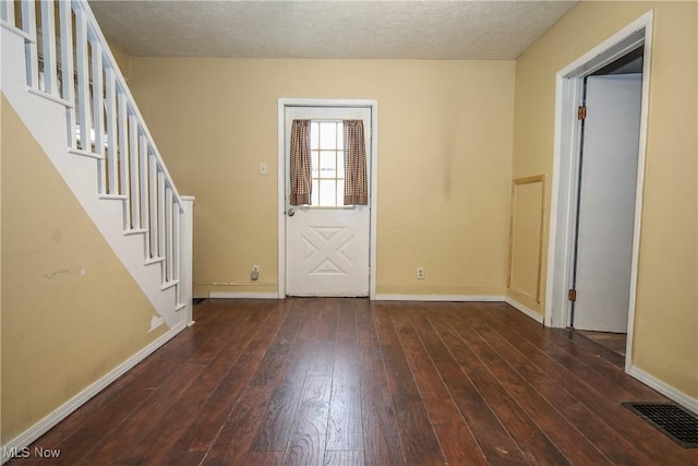 entryway with baseboards, visible vents, stairway, dark wood-style flooring, and a textured ceiling