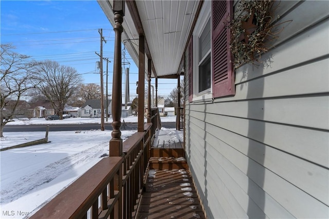 view of snow covered exterior with covered porch