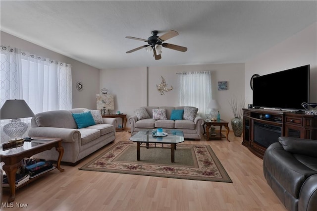 living room with light wood-style flooring and a ceiling fan