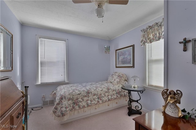 bedroom featuring a ceiling fan, light colored carpet, visible vents, and baseboards