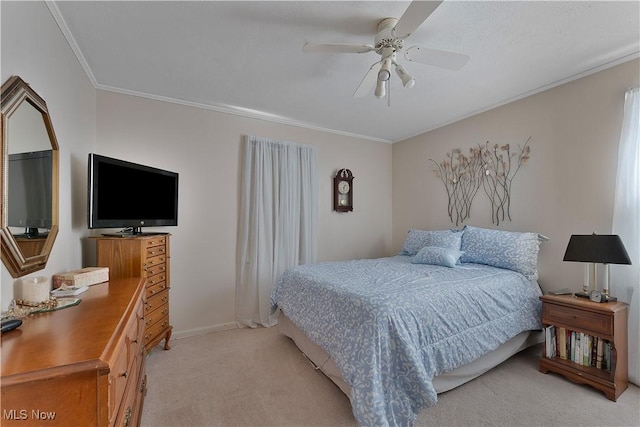 bedroom with baseboards, ornamental molding, a ceiling fan, and light colored carpet