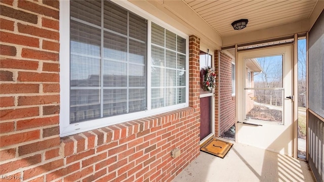 property entrance featuring brick siding