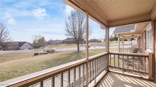 balcony with covered porch and a residential view