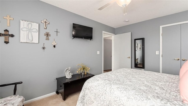 bedroom featuring baseboards, ceiling fan, and light colored carpet